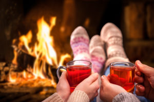 Cozy picture with a warm fireplace and hot cider