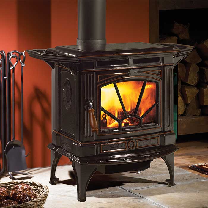 Hampton antique look wood burning stove black with tools to the left and stone hearth