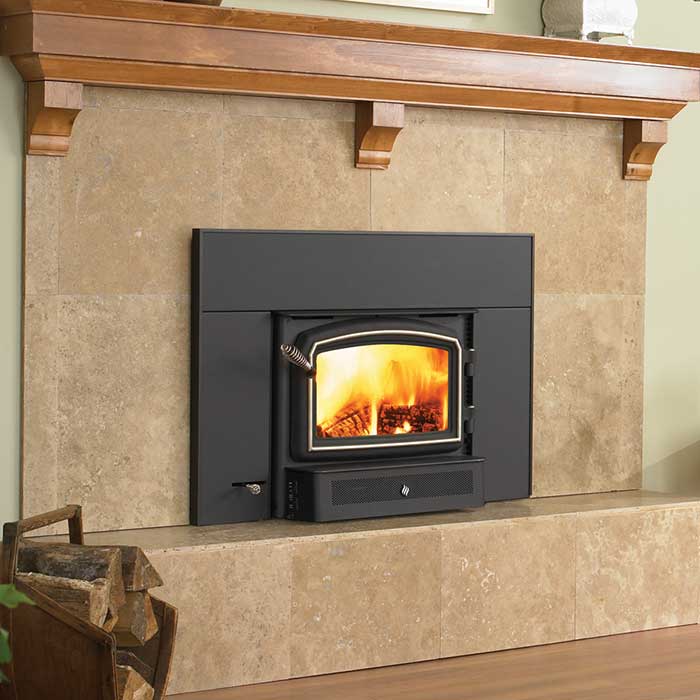 Wood burning insert with black facing stone surround and wood mantle