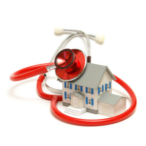 mini house model with red stethoscope around it