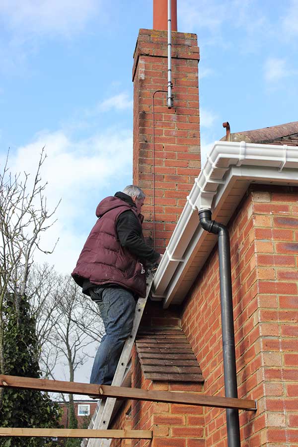 Original Photo-Chimney Leaks- Billy Sweet Chimney Chimney Tech working on leak repair of a chimney